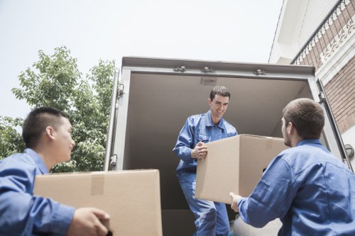 Boxes and furniture being placed in a new Hither Green property