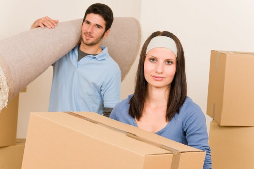 Local moving truck loading furniture and boxes near Hither Green properties
