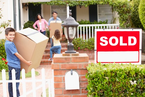 Packed moving boxes and furniture ready for removals in Hither Green