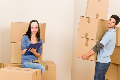 Packed moving boxes and furniture ready for loading in Hither Green
